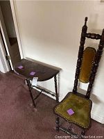 Photo showing both hall chair with green velvet upholstery and matching half-moon side table with turned legs