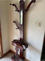 Full view of the hall stand showing the central mirror, hooks, and base structure