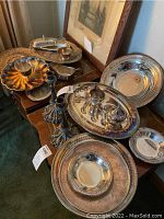 All pieces grouped on wooden table under framed art