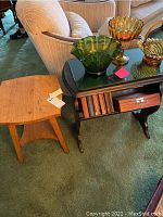 Oak stool and small bookshelf next to a couch