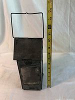 Full view of antique Stonebridge folding candle lantern next to measuring tape showing height at 11 inches.