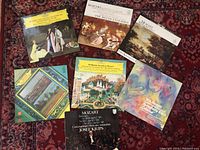 Top-down view showing all seven Mozart LP records on a patterned cloth.