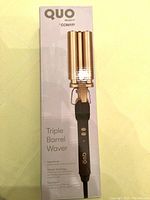 Photo of original packaging box for Conair Quo Triple Barrel Waver with image of device shown on box.