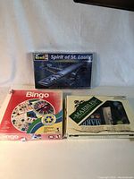 Photo showing entire lot: Revell Spirit of St. Louis model airplane kit box, Bingo game box, and Marbles game box side by side.