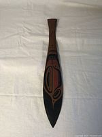 Full view of paddle showing its shape and painted design.