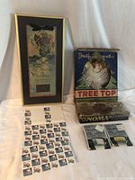 Overall display of framed Christmas message, NOMA box, stamps, and light bulb boxes with tree top angel