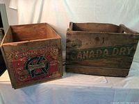 Wooden Canada Dry and OK Apple crates side by side showing overall size and condition.