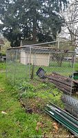 Assembled kennel frame with chainlink panels in yard