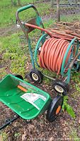 Seed spreader and hose reel showing overall lot condition and components.