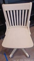 Front and top view of white wooden desk chair with vertical slat backrest and curved armrests