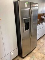 Exterior view of stainless steel side-by-side refrigerator with dispenser