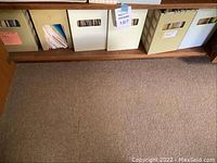 Shelf showing four beige plastic filing boxes containing recipe folders.