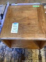 Top view of one wooden end table showing framed wood top and natural finish.