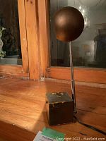 Unlit lamp from front-left angle showing cube base and spherical shade