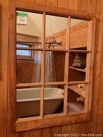 Front view of the 9-pane window-style mirror showing the pine frame and divided glass panes.