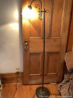 Full view of lamp showing brass-finish stand and frosted glass shade