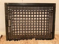 Full image of large cast iron grate with honeycomb pattern and frame showing overall condition and shape.