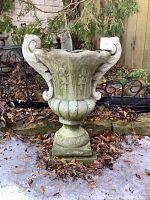 Front view of the old garden cement planter urn, showing ornate detailing and condition.