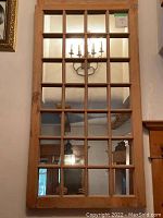 Front view of entire pine window-style mirror showing all 28 panes