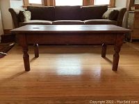 Front view of rectangular plank top coffee table in living room