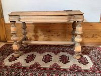 Front and side views of an unfinished pine bench with turned legs and rectangular top showing dimensions and wood grain.