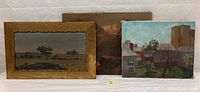 Three paintings displayed side by side: pastoral landscape in gilt frame, mountain lake scene, and urban homes view