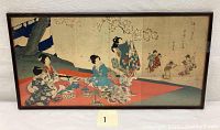 Framed triptych woodblock print showing full scene of geisha on red mat beneath cherry tree