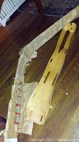 Both Eames leg splint and decorative ladder laid out on floor
