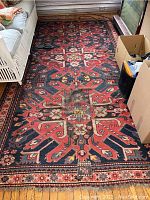 Full top view of 10x5 ft woven knotted area rug showing geometric star medallion pattern and surrounding multi-tiered borders