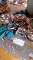 Overview of all items on wooden surface, showing arrangement of dishes, flatware, shakers and accessories
