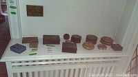 Overall display of approximately 15 boxes lined on radiator cover