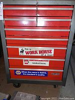 Front view of red Craftsman rolling tool cart with stickers and lockable drawers