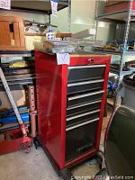 Front view of red Craftsman rolling tool chest on wheels