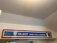 Full view of the framed Talbot 1981 World Rally Champions banner on a wall.
