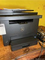 Front view of Dell E525w printer showing paper trays and Dell logo.