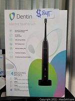 Photo of the Dentin electric toothbrush box showing product features and condition tag $84T.