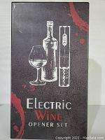 Front of box showing electric wine opener set graphic with bottle, glass, and opener.