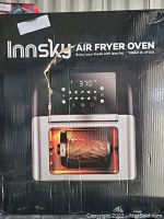 Photo of the outer box packaging of the Innsky Air Fryer Oven model IS-AF001, showing brand, model, and front display image of the product in use.