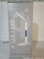 Front view of the LED lamp box showing the image of the lamp and key features like touch control.