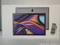 Box front showing image of the silver tablet with screen and back view bearing Magch branding