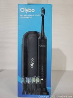 Front of blue box showing Olybo rechargeable sonic toothbrush handle, travel case, and six brush heads.