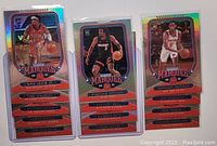 Photo of three rookie basketball cards in protective sleeves showing players Kirk Jenkins, Precious Achiuwa, and Emmanuel Quickley from Panini Chronicles Marquee 2020-2021 set.