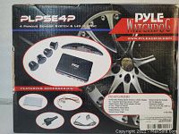 Front of box showing Pyle Watchdog PLPSE4P 4 Parking Sensor System with LED display and four sensors graphic, featuring accessories image.