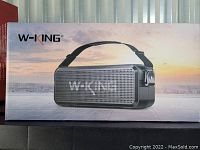 Box with image of the W-King branded portable wireless speaker with shoulder strap, showing model and Logo.