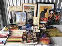 Full view of all art books, posters and decorative masks arranged together showing the variety and condition of the lot.