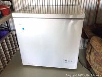 Front exterior view of white Danby chest freezer in storage unit