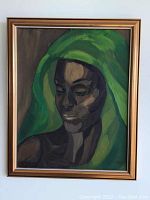 Full view of framed painting showing a person with green head covering.