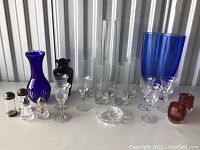 Wide view of entire lot showing all glassware on table including colored and clear pieces