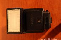 Top view of the Canon flash unit showing the white diffuser and Canon branding.