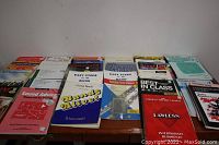 Photo showing the front covers of multiple music instruction books arranged side by side including band and general music education books.